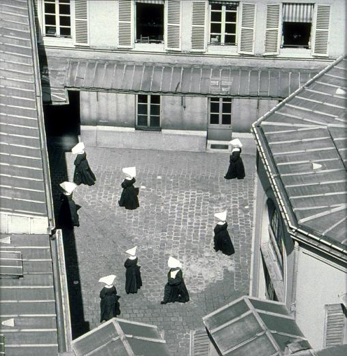 Sœurs dans la cour de St Vincent-de-Paul, Paris vers 1950 by Almasy Paul